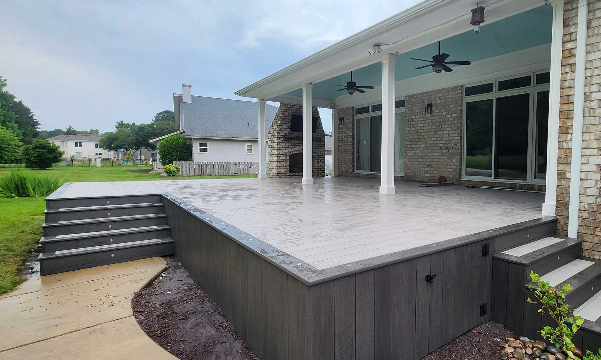 Form-map-backg A spacious backyard with a custom deck installation featuring composite decking and an outdoor fireplace, showcasing professional craftsmanship and durable materials, perfect for enhancing outdoor living in Virginia Beach.| First In Decks and Fencing | Virginia Beach Deck Builders