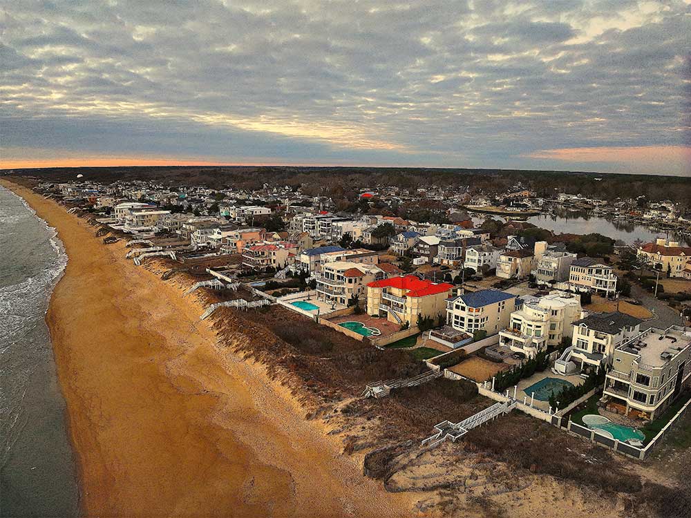 Aerial view of a coastal neighborhood in Virginia Beach with homes featuring durable materials for custom decks and outdoor living spaces, reflecting high-quality craftsmanship and…| First In Decks and Fencing | Virginia Beach Deck Builders